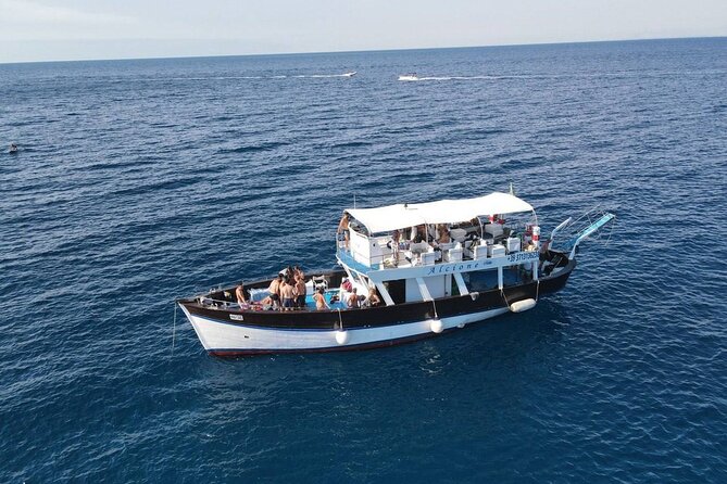 Boat tour with lunch on board to discover Procida - Lacco Ameno and Baia di San Montano: bruschetta, snorkel-friendly water, and a calmer coastline