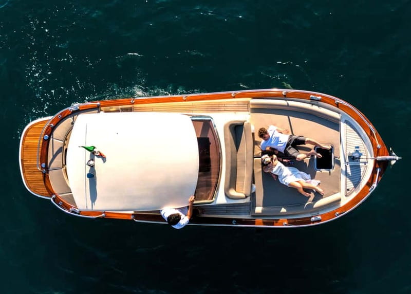Capri : 2 Hours Private Boat from Capri - Faraglioni rocks, Casa Malaparte, and Tiberio’s Jump in a smart photo loop