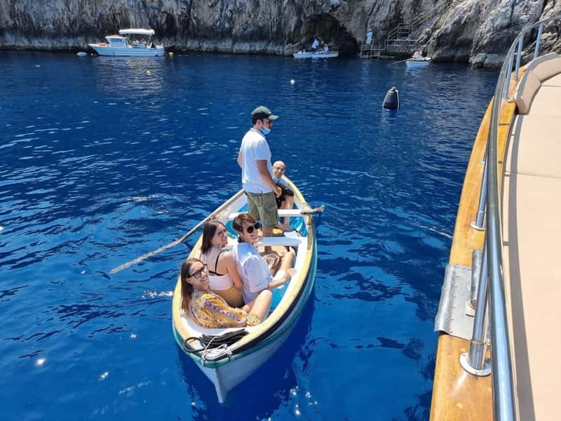 Capri and Blue Grotto Day Tour From Sorrento with 8 People - Capri by sea: Faraglioni, colored grottoes, and Punta Carena views