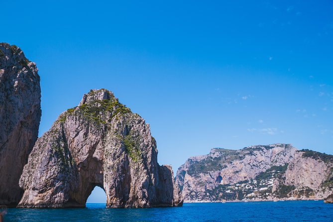 Capri Boat Tour: Grottoes, Swim & Sip Limoncello in a Small Group - Capri’s Sea Icons: Natural Arch, Villa Malaparte, and the Faraglioni Show