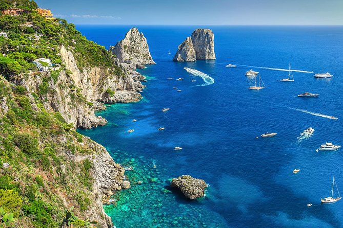 Capri by Sea Private Boat Excursion - Pink and white lighthouse pass-by at the island’s southwest tip