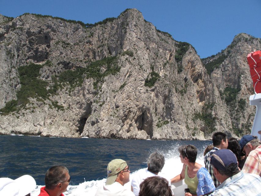Capri: Private Island Boat Tour with Snorkeling and Swimming - Faraglioni Rocks and the natural arch, seen at water level