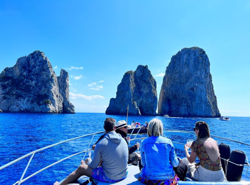 Discover Capri's Hidden Gems: Group Tour Boat Experience - Captain-led views: Faraglioni, cliff towns, and the local story