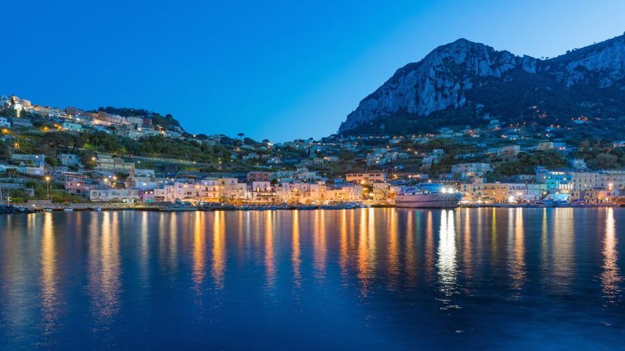 From Sorrento: Capri Boat Tour Day & Night Experience - Boat views of grottos, Faraglioni, and the famous coastline stops