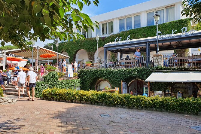 Shared CAPRI Tour - 360° experience by Bus, Boat & Guide - Entering Capri at Marina Grande, Then Going Straight for the Views